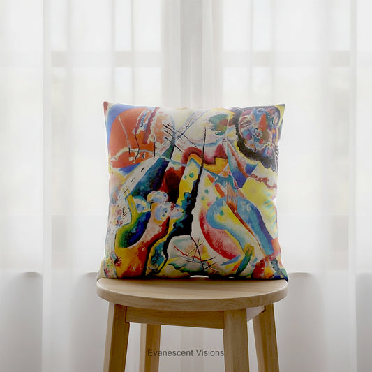 A square cushion featuring a print of the abstract, multicolored painting 'Bild mit Rotem Fleck' by Wassily Kandinsky, shown on a brown stool.