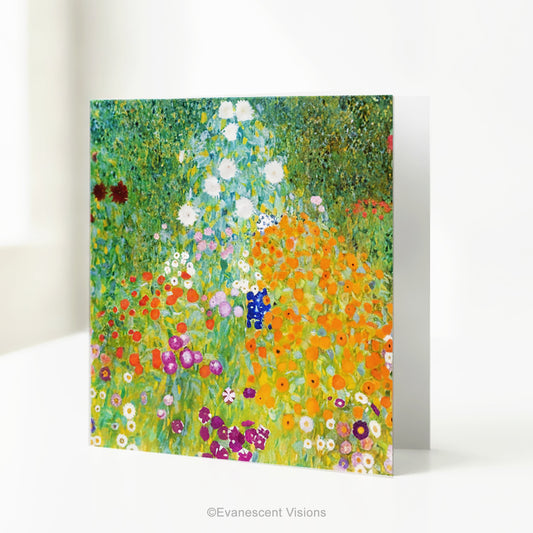 A square art print greeting card with Gustav Klimt arwork 'Bauergarten' a colorful impressionist-style wildflower meadow, standing on a white table.