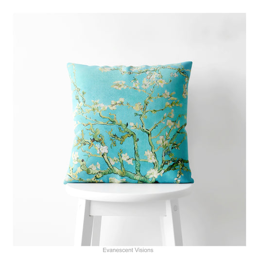 A square decorative cushion featuring Vincent van Gogh's 'Almond Blossom' painting design, shown on a plain white stool.