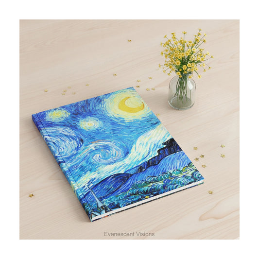 A hardback journal featuring Van Gogh's Starry Night painting, laying on a wooden desk surrounded by golden stars and a small vase of flowers.