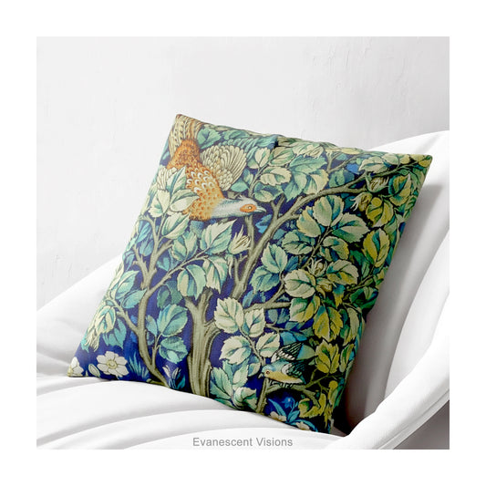 A square decorative cushion on a white chair with design 'Cock Pheasant ' by William Morris.