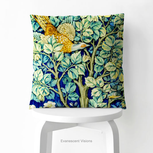 A square decorative cushion on a white chair with design 'Cock Pheasant ' by William Morris.