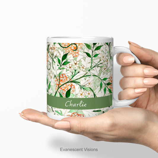 A Personalised William Morris Patterned mug being held in a woman's hand