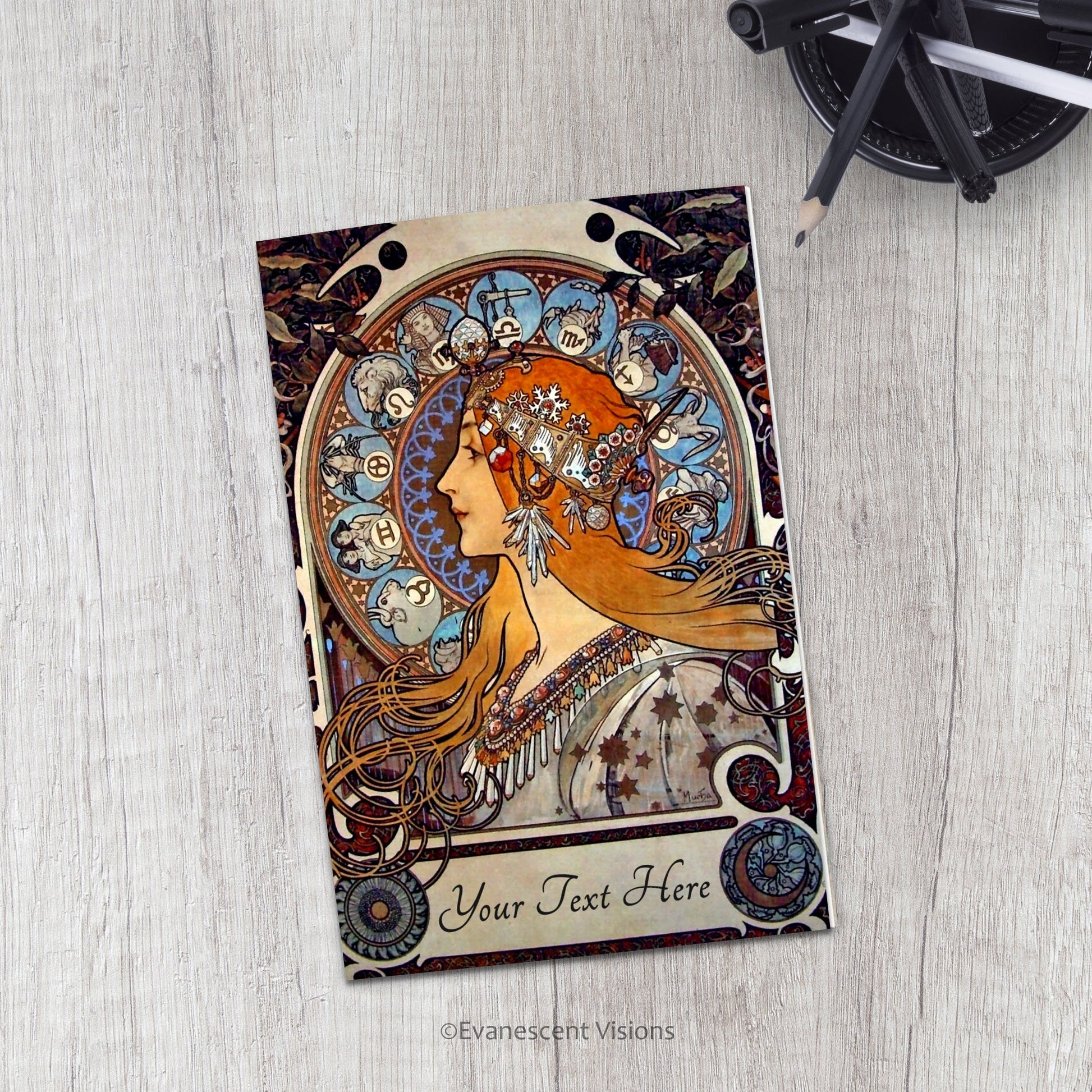 Evanescent Visions Art Nouveau Zodiac Card on a desk with pens