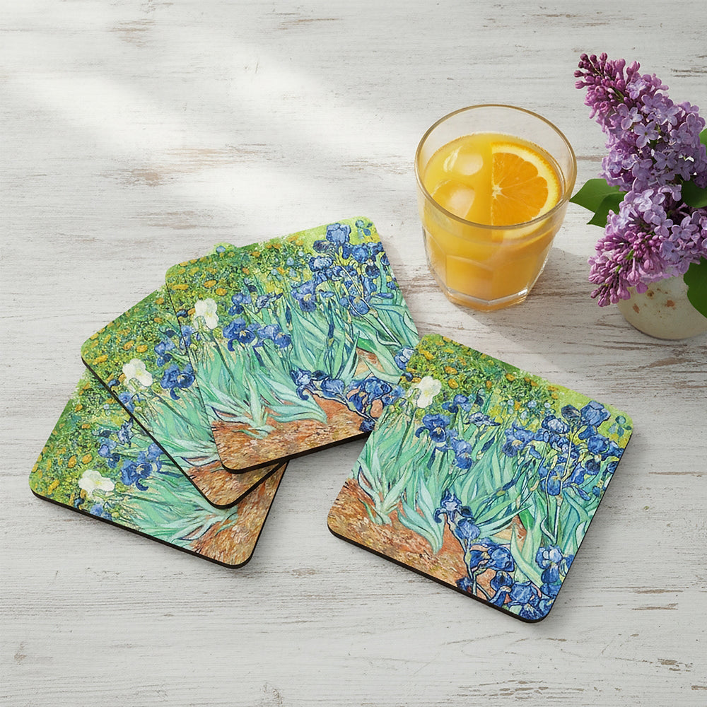 Set of 4 coasters with paintings on a table top with coffee mugs