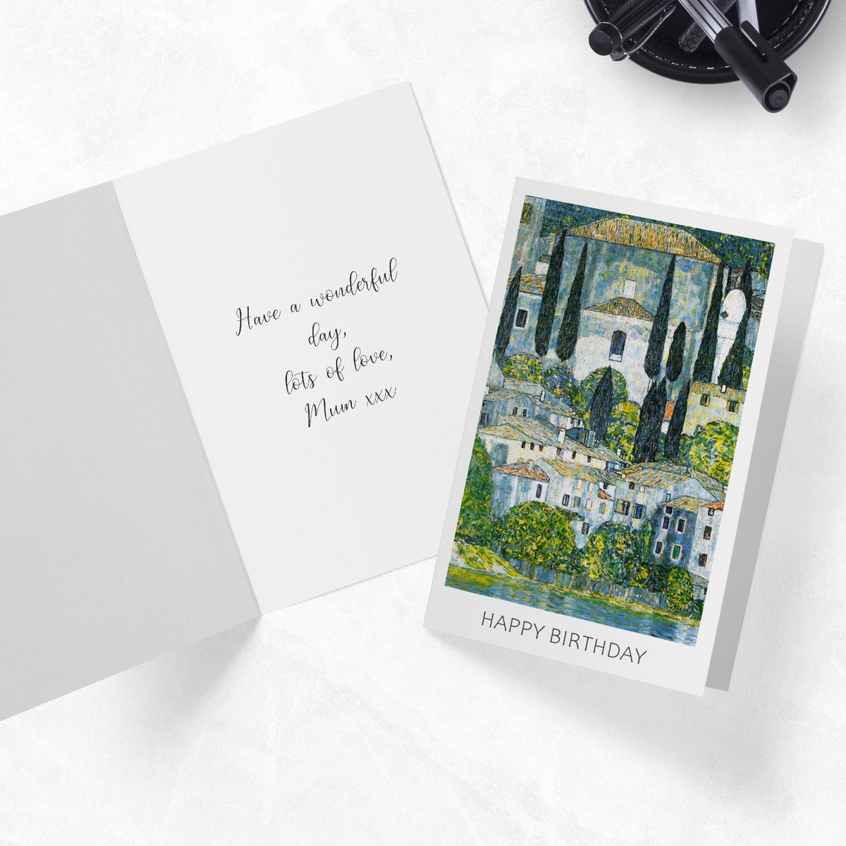 Evanescent greeting cards on a desk with an inside view of one card