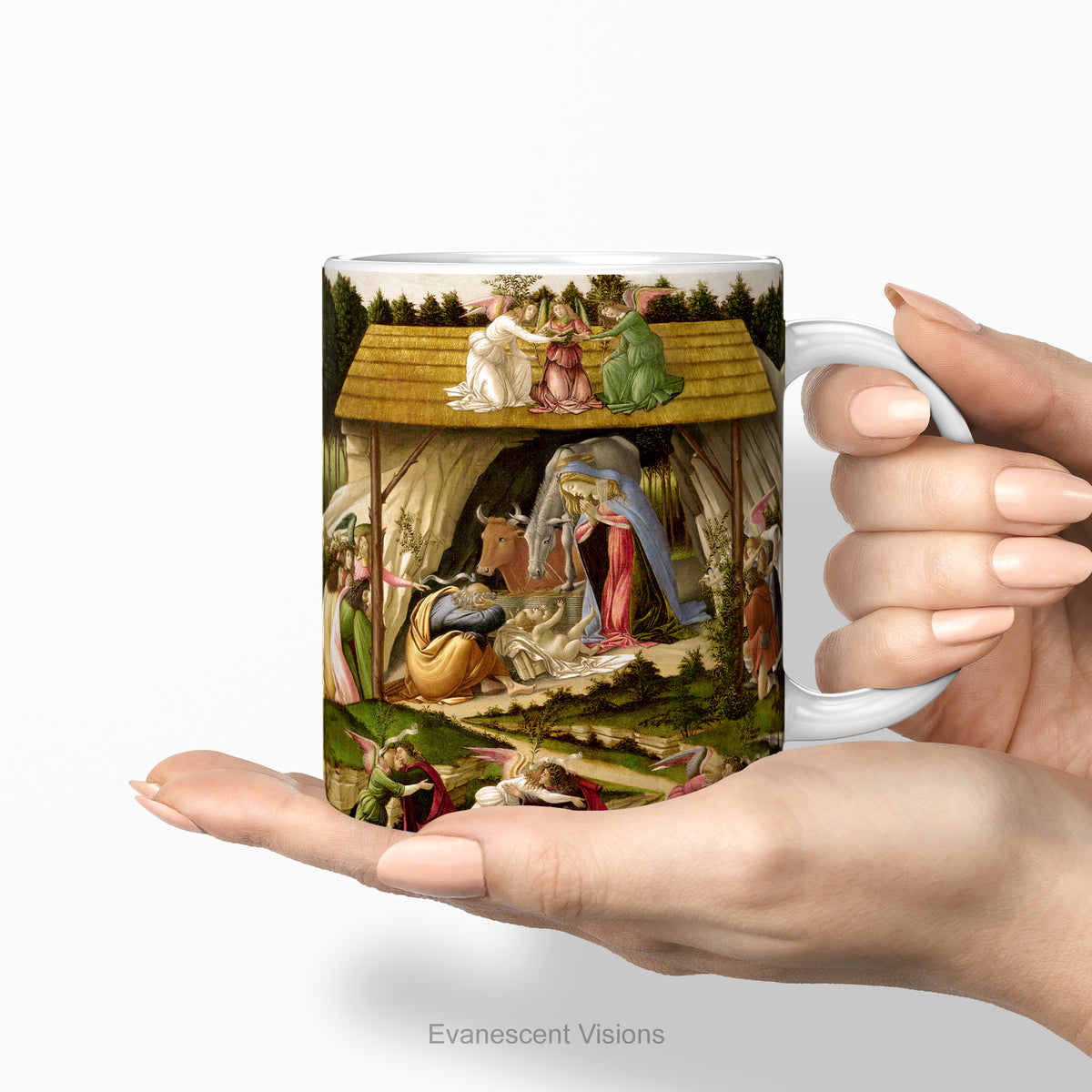 Hands holding a white ceramic mug with a print of the nativity scene painting 'Mystic Nativity' by Sandro Botticelli.