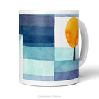 A white ceramic mug featuring a watercolor-style abstract landscape print called 'Harbinger of Autumn' by Paul Klee, on a white background. 