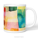 A white ceramic mug featuring a colorful abstract watercolor print with blocks of teal, yellow, pink, orange, and green called 'Untitled' by artist Paul Klee, shown on a white background. 