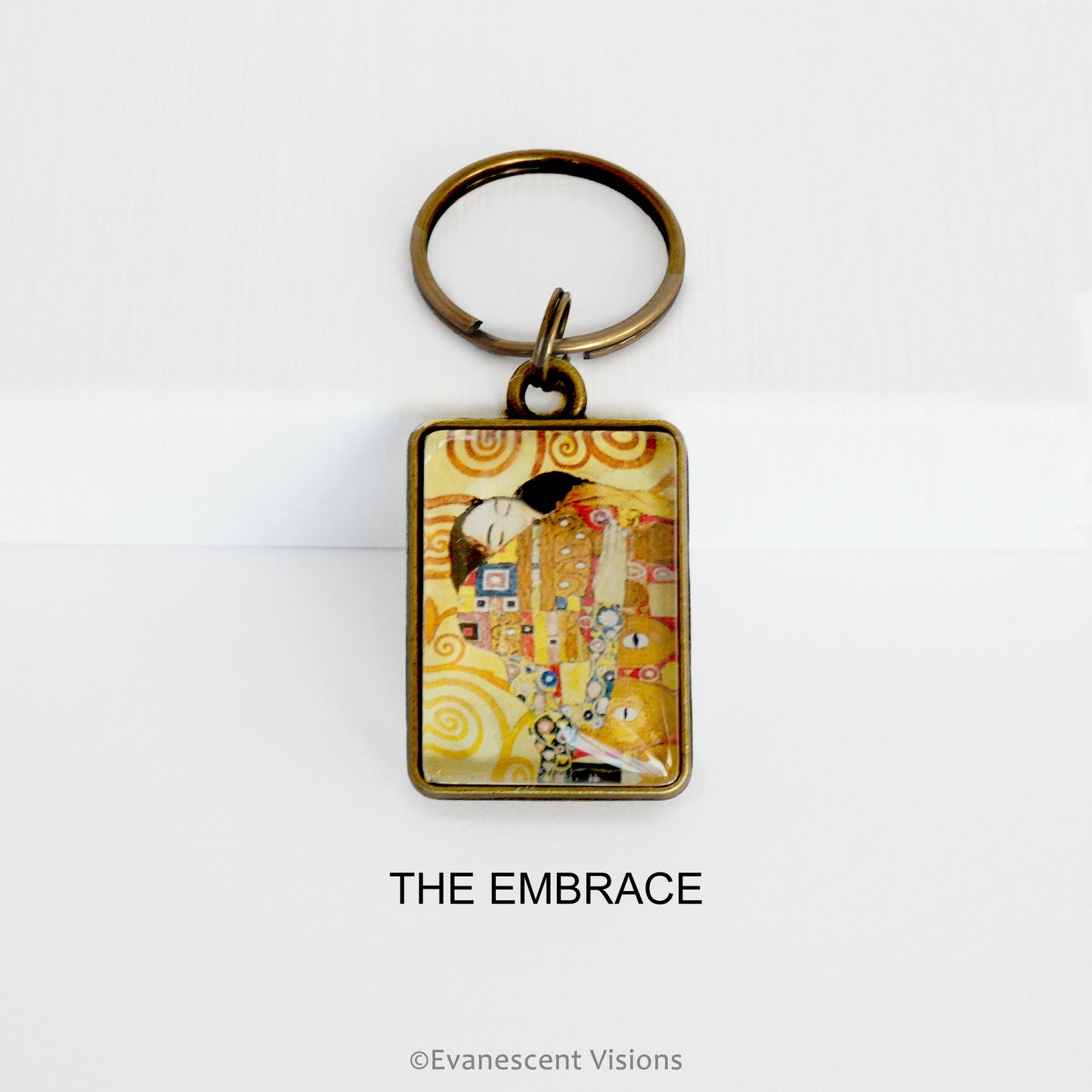 Keychain with 'The Embrace' design by Gustav Klimt on a white background