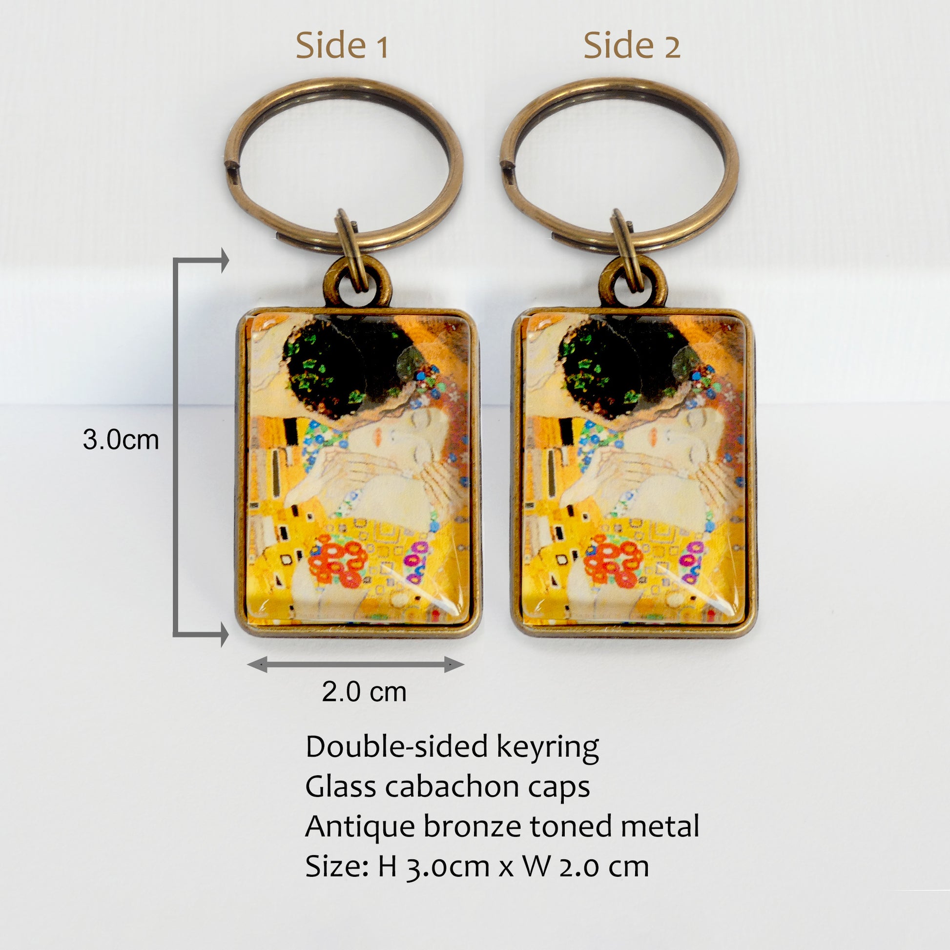 Two keychains with artistic design The Kiss by Gustav Klimt, labeled 'Side 1' and 'Side 2', on a white background with product details