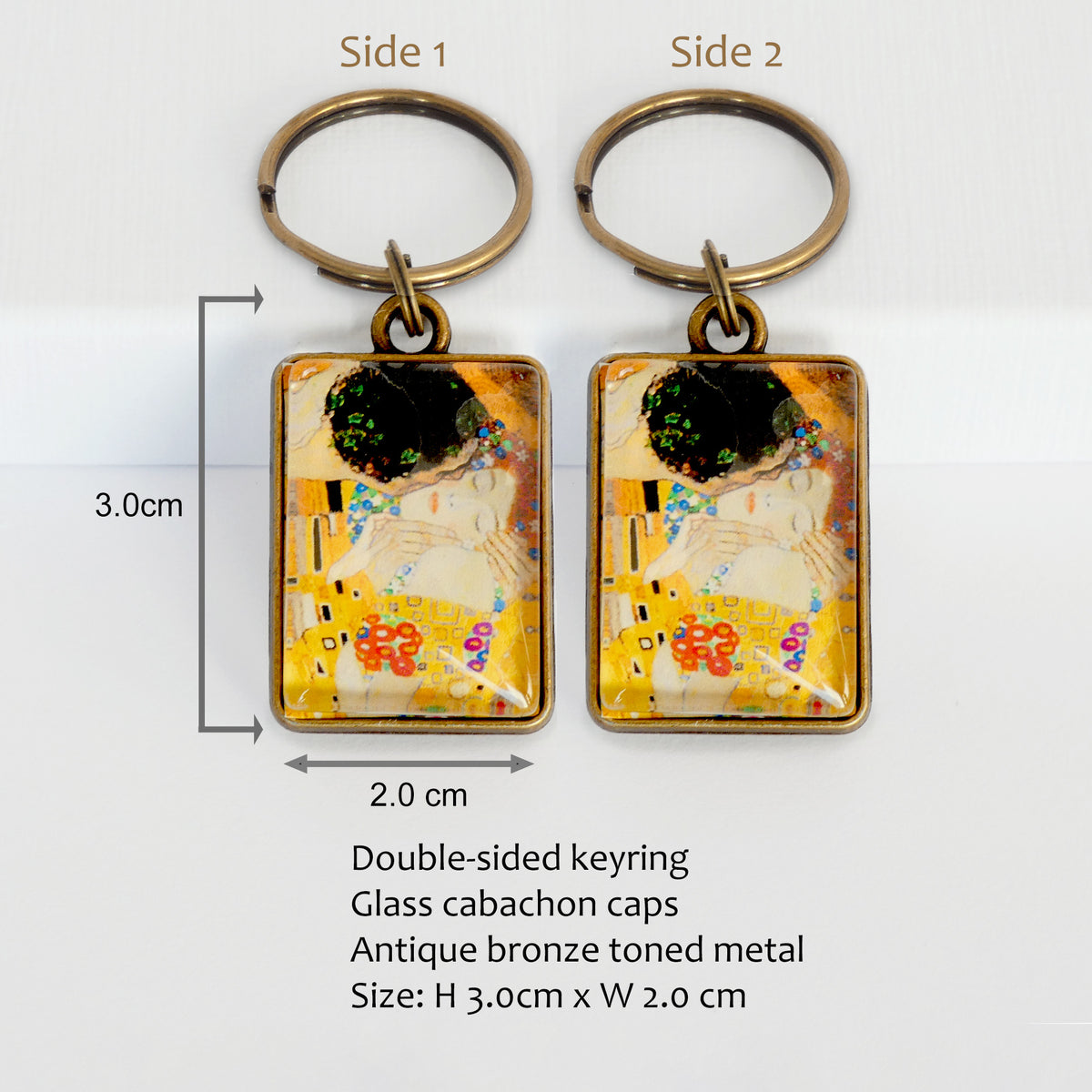 Two keychains with artistic design The Kiss by Gustav Klimt, labeled 'Side 1' and 'Side 2', on a white background with product details