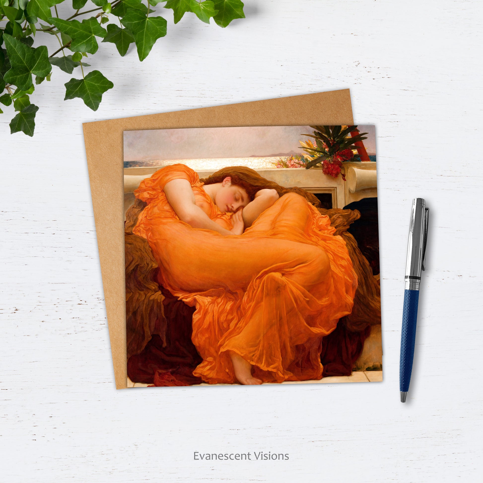 Card and envelope with design of Frederic Leighton's 'Flaming June' on white surface with pen and ivy.