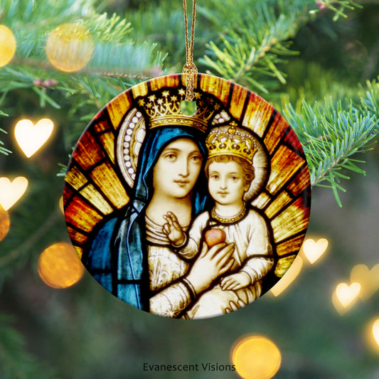 Ceramic Christmas ornament with stained glass window detail of Mary and Jesus. The ornament hangs with a gold thread from a Christmas tree and is surrounded by golden hearts and circles.