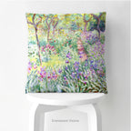 A square decorative cushion  featuring an impressionist floral artwork 'The Artist's Garden' by Claude Monet, on stool.