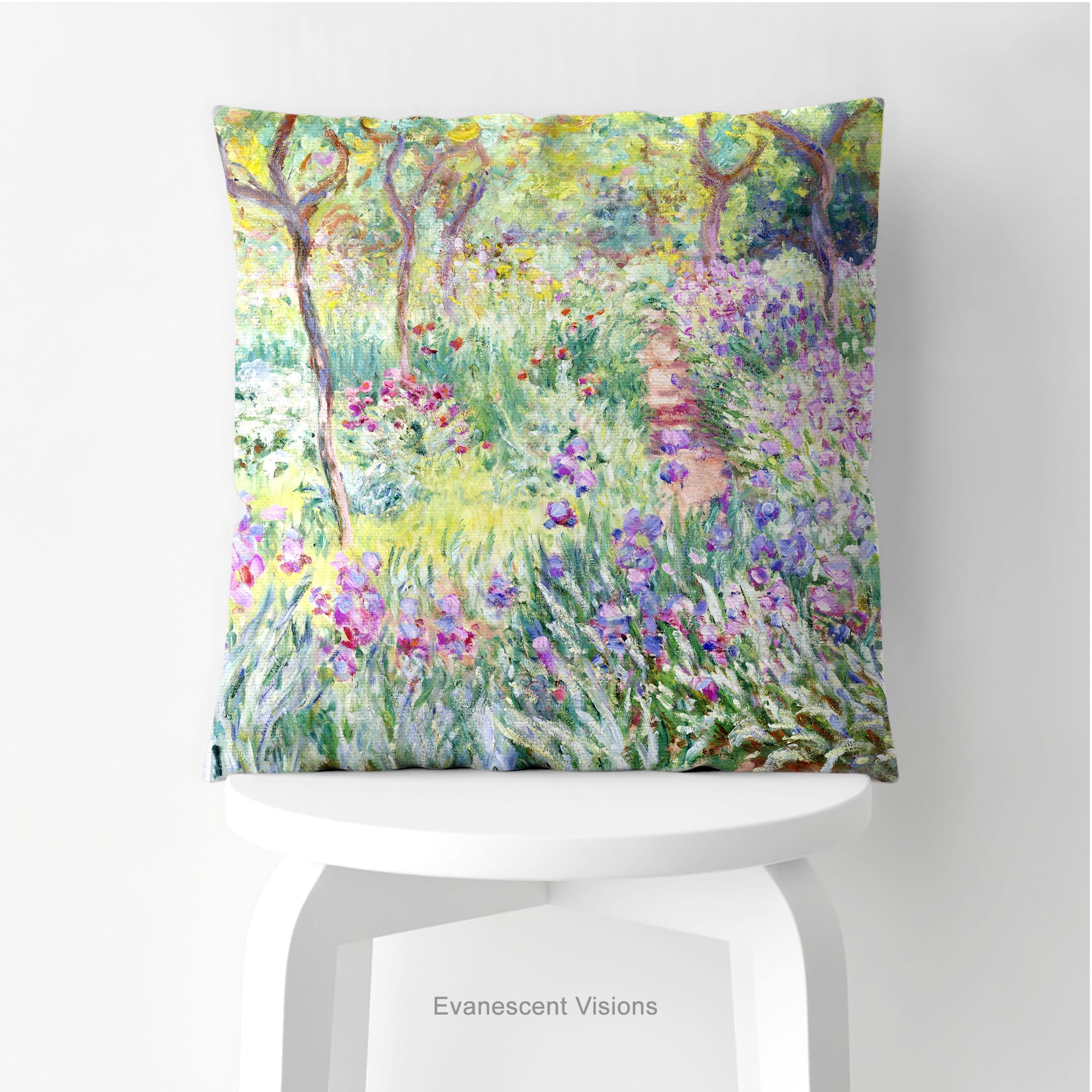 A square decorative cushion  featuring an impressionist floral artwork 'The Artist's Garden' by Claude Monet, on stool.