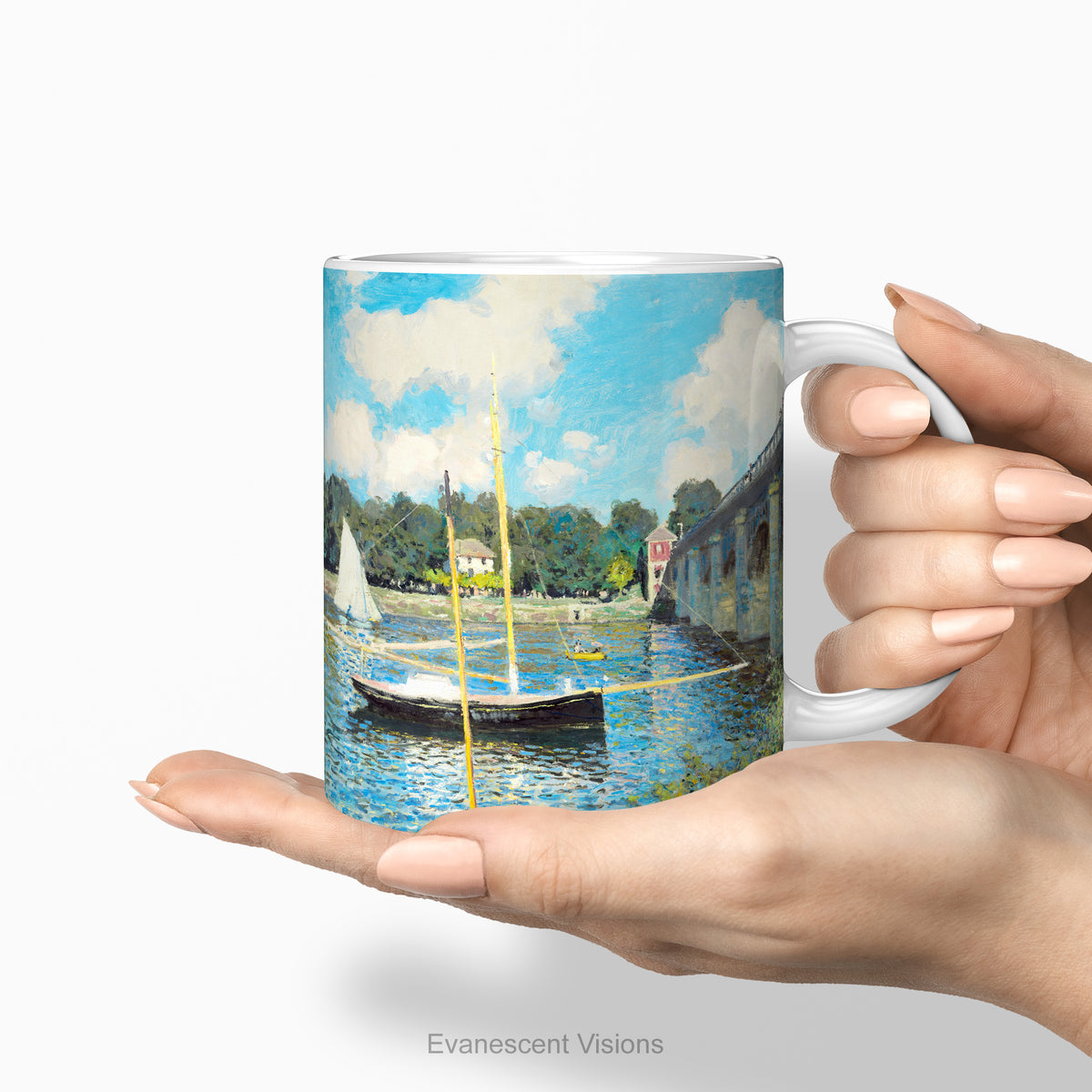 Hands holding the ceramic mug with a print of  impressionist painting 'Bridge at Argenteuil' by Claude Monet 