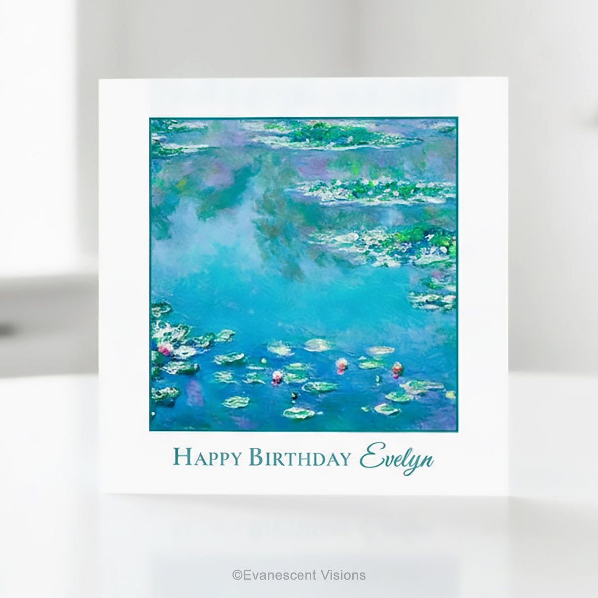 A square greeting card with a white border featuring Claude Monet's impressionist Water Lilies painting  in blue, green, and purple tones, with the text 'Happy Birthday Evelyn' printed below.