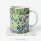 A ceramic mug with a print of artwork The Artist's Garden at Giverney' by Claude Monet