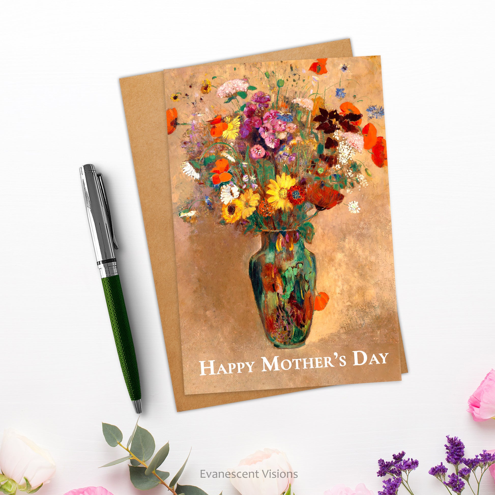 Card and envelope. Card has bouquet of flowers in vase and the words, 'Happy Mother's Day' on the front. They are shown on a white surface next to a pen and with flowers near the bottom.