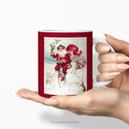 Hands holding a ceramic C Mug, with a vintage Christmas illustration of Santa Claus on a Penny Farthing bicycle. 