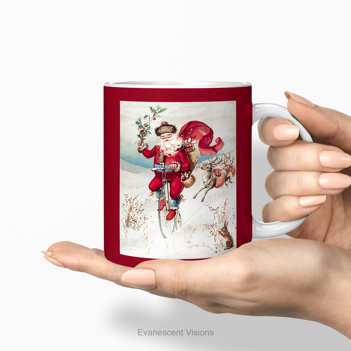 Hands holding a ceramic C Mug, with a vintage Christmas illustration of Santa Claus on a Penny Farthing bicycle. 