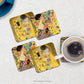 Set of 4 Coasters with Klimt Women Paintings on a table top