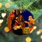 Ceramic Christmas Ornament with a colourful Nativity Scene design, hanging from a Christmas tree