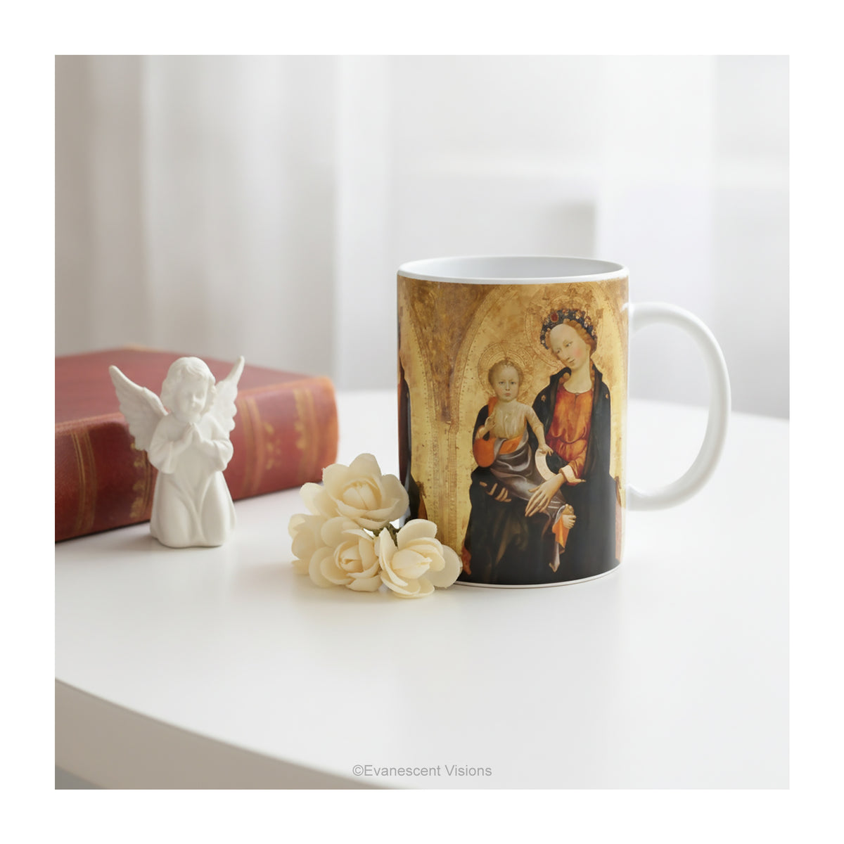 Ceramic mug with a print of Renaissance painting 'Madonna and Child', styled on a table.