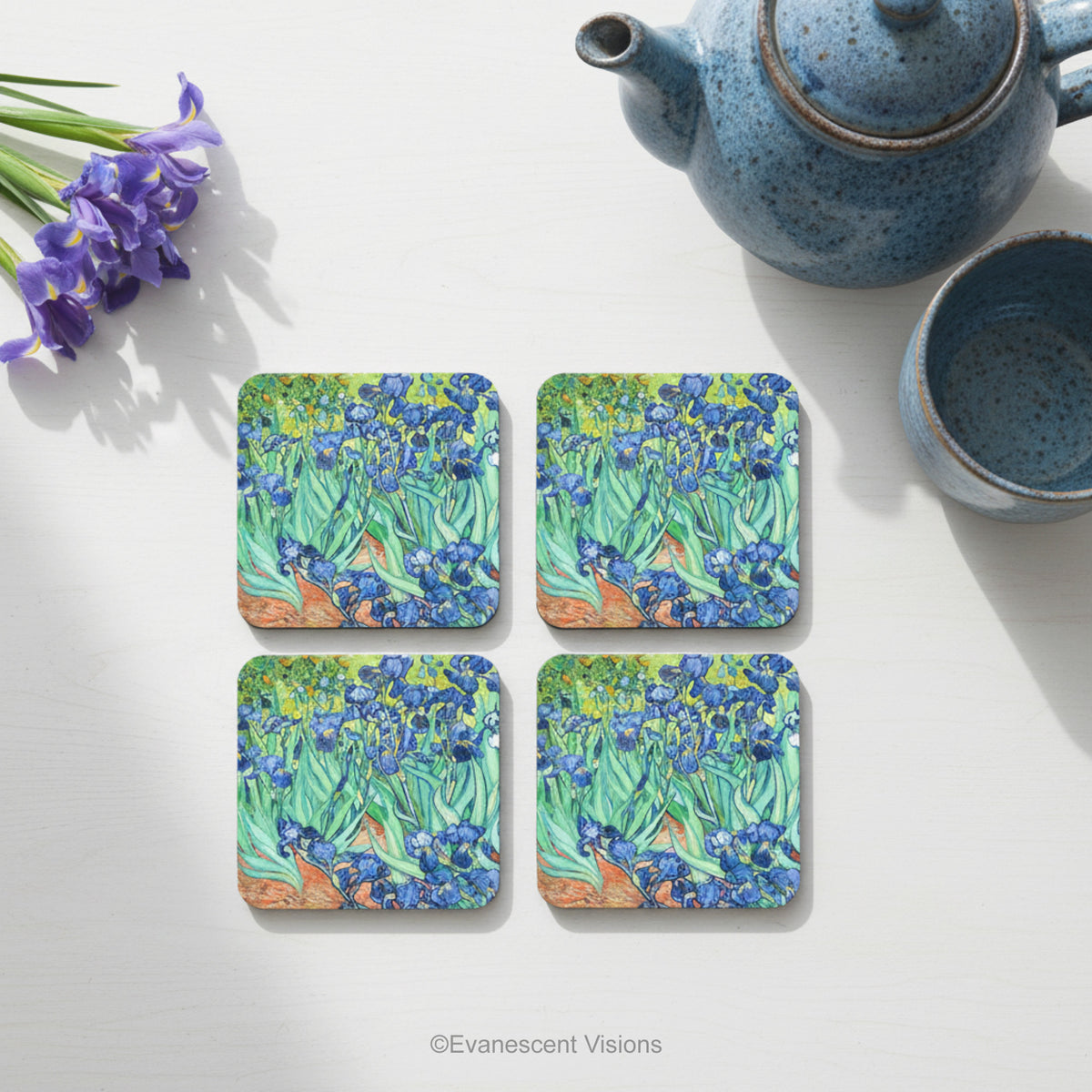 Set of 4 coasters with the painting 'Irises' on the front, by Van Gogh, shown on a table with tableware.