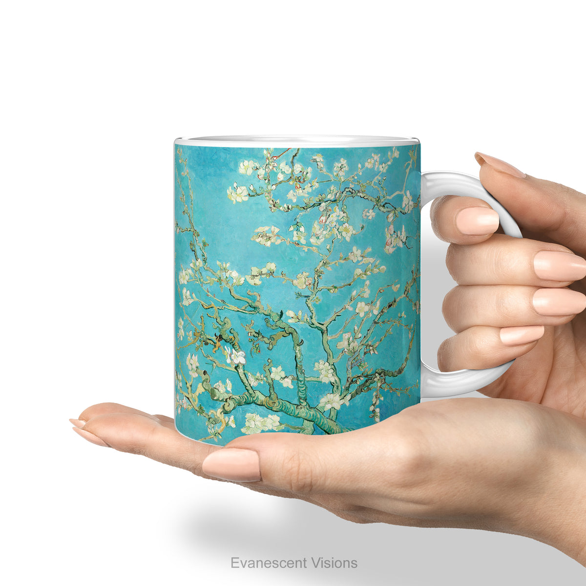 A hand holding the ceramic mug featuring Vincent van Gogh's 'Almond Blossom' painting design.