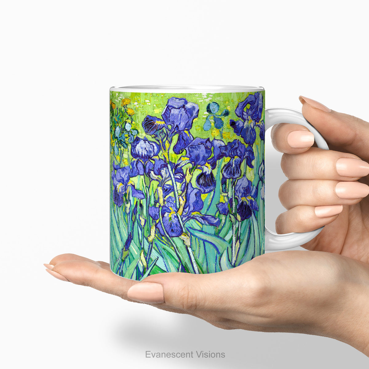Hands holding a ceramic mug featuring a print of artwork  'Irises' by Vincent Van Gogh.