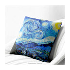 A square artistic themed cushion featuring Vincent van Gogh's 'Starry Night' painting' in blue and yellow tones, shown on a white armchair.