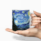 Hands holding a ceramic mug featuring artwork 'The Starry Night' by Vincent Van Gogh