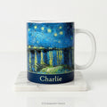 Ceramic mug with Van Gogh's painting Starry Night Over the Rhône, in blue and yellow tones, with a personalised name below. 