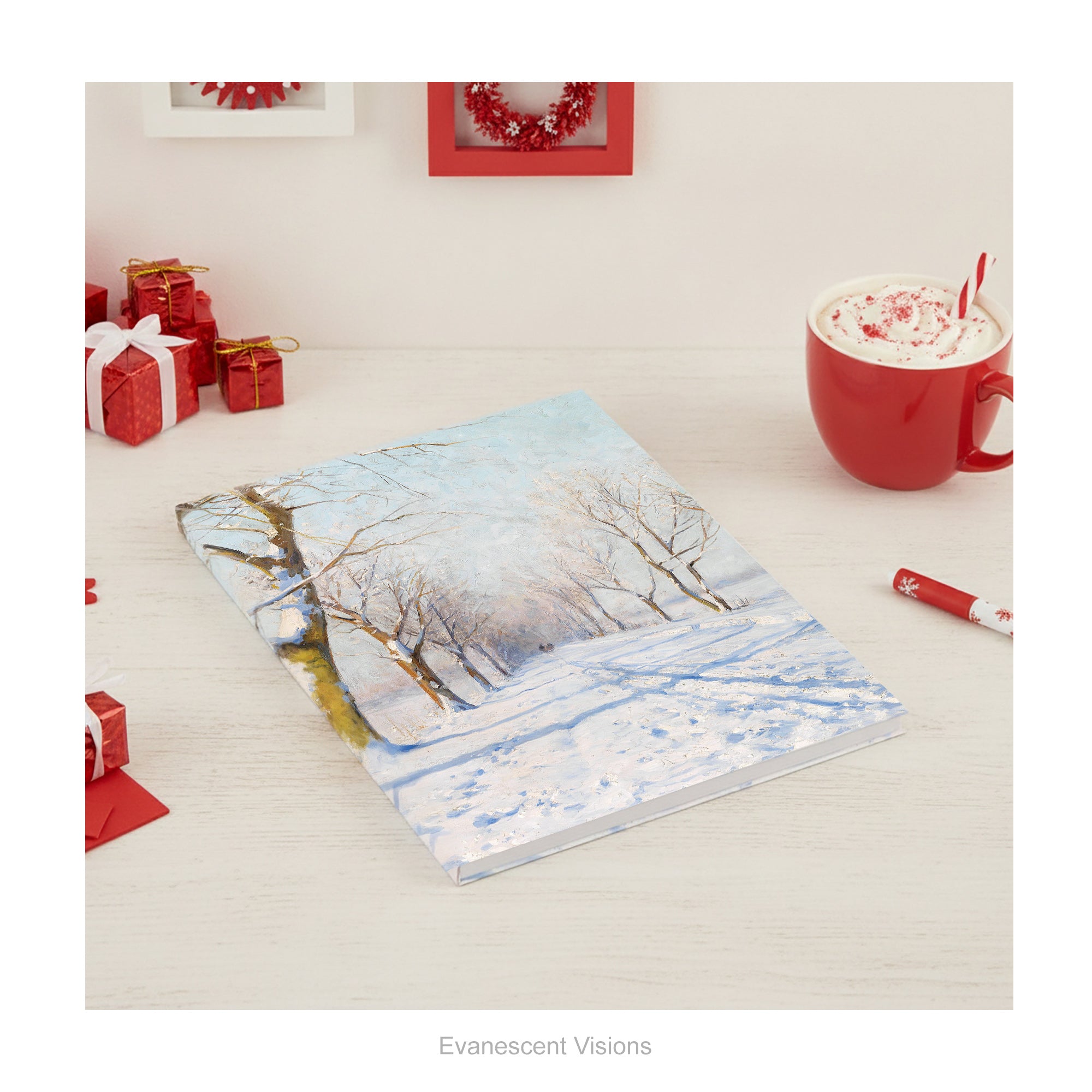 A hardback notebook featuring  a winter landscape from painting A Sunny Winters Day by Walter Moras, shown on a wood desk. 