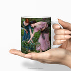 Hands holding a ceramic mug featuring painting 'Gather Ye Rosebuds While Ye May '.