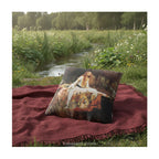 A square decorative cushion  featuring the painting 'The Lady of Shalott' by JW Waterhouse, shown a red blanket by a small river. 