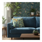 A square decorative cushion  with design 'Cock Pheasant ' by William Morris, on a blue sofa in a botanical themed room. 