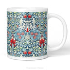 A white ceramic mug featuring a detailed, symmetrical floral pattern in navy blue, sage green, and red called Snakeshead by William Morris,   shown on a clean white background .