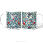 Left and right side views of a white ceramic mug featuring a detailed, symmetrical floral pattern in navy blue, sage green, and red called Snakeshead by William Morris,  shown on a clean white background .