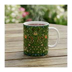 A ceramic mug with design 'violet and Columbine' by William Morris, styled on a table. 