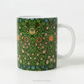 A ceramic mug with design 'violet and Columbine' by William Morris.