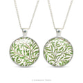 Front and back views of the double sided cabochon pendant necklace with detail from the design  'Willow bough' by William Morris