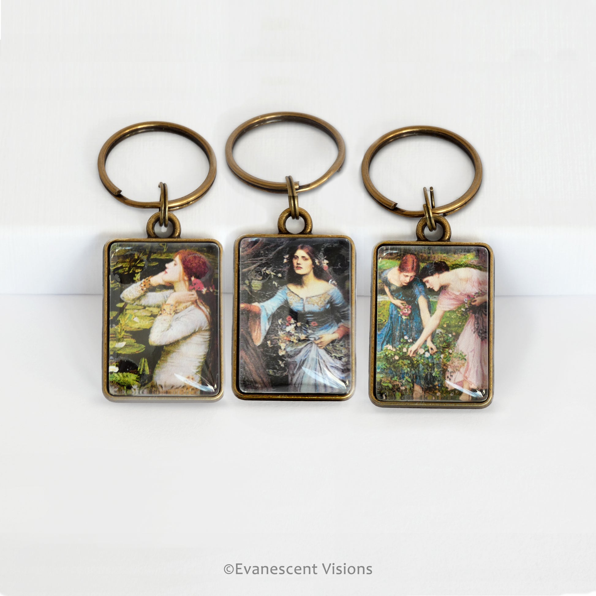 Three keyrings with Pre-Raphaelite art by John William Waterhouse on a white background