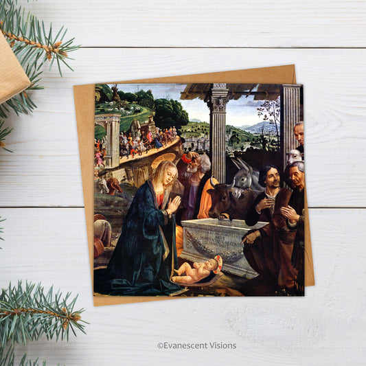 Adoration of the Shepherds Renaissance Nativity Scene Christmas Card lying on a wood desk surrounded by fir branches and gifts
