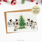 Puppies and Dogs around a Christmas Tree Fine Art Xmas Card standing on a table