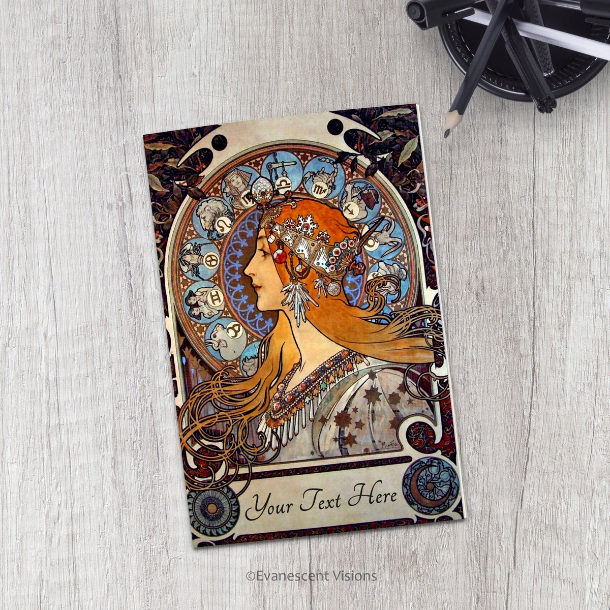 Evanescent Visions Art Nouveau Zodiac Card on a desk with pens